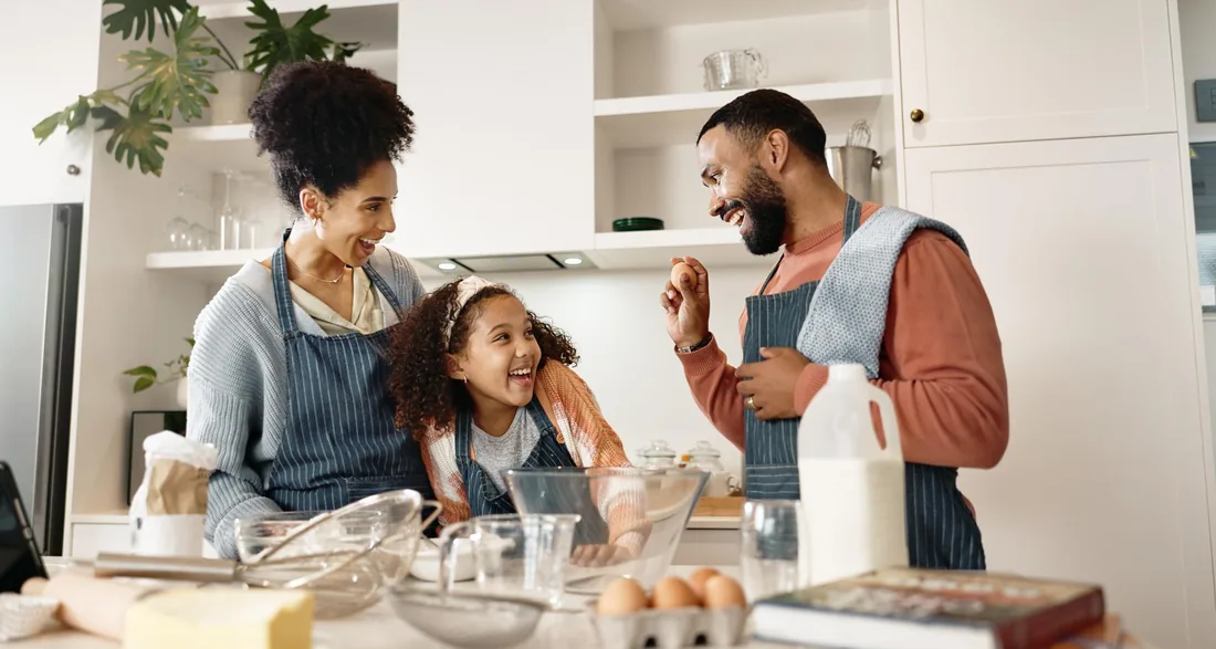 Couple preparing vegetables together on a kitchen island